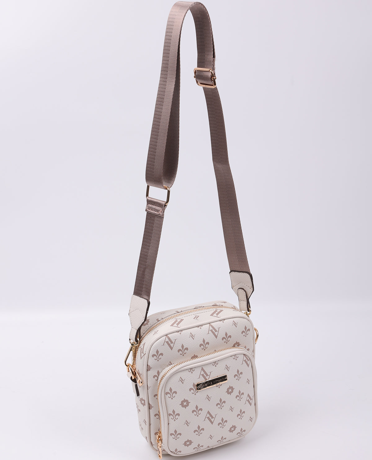 Small crossbody bag with floral pattern on a light gray background