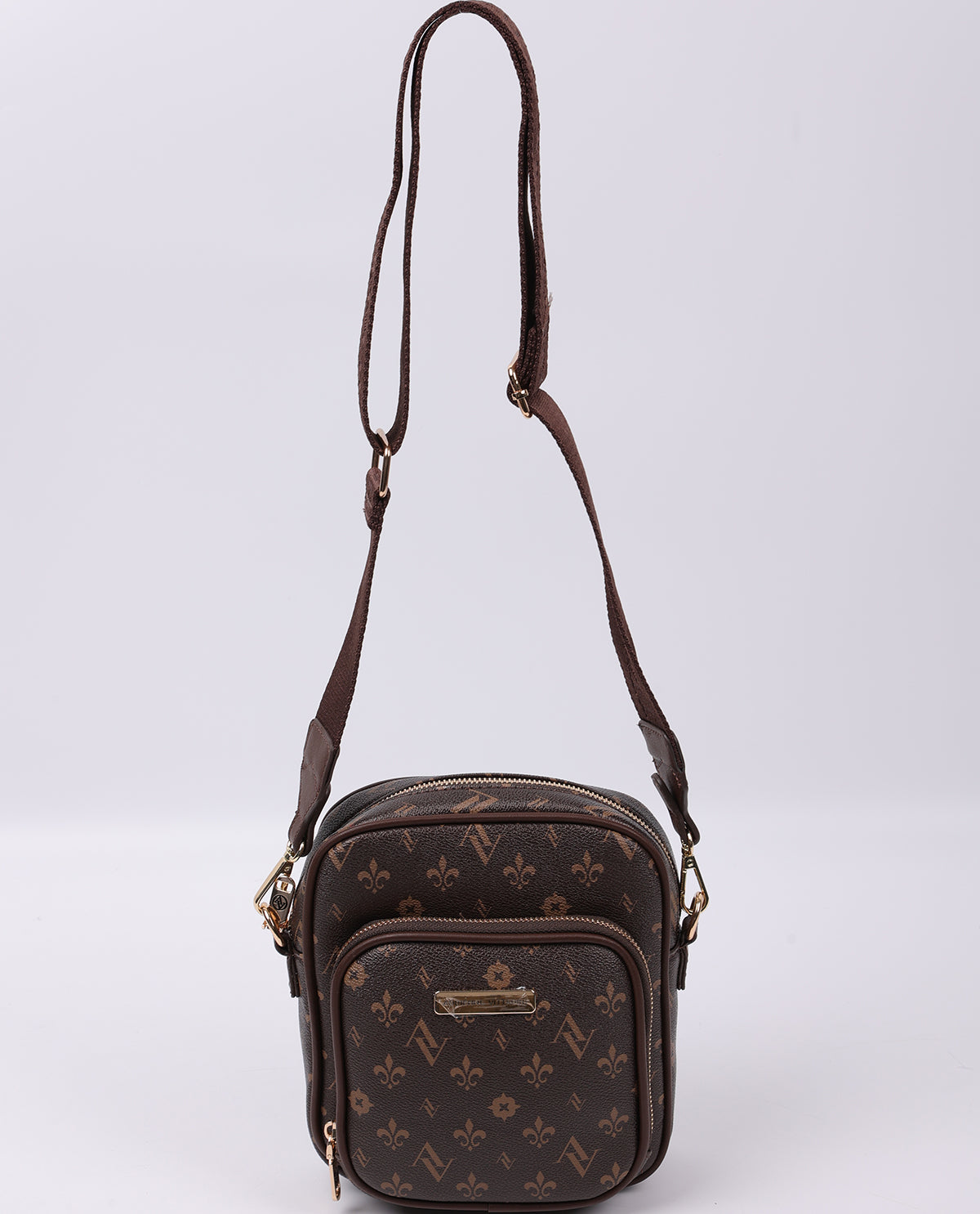 Brown patterned crossbody bag on a light gray background