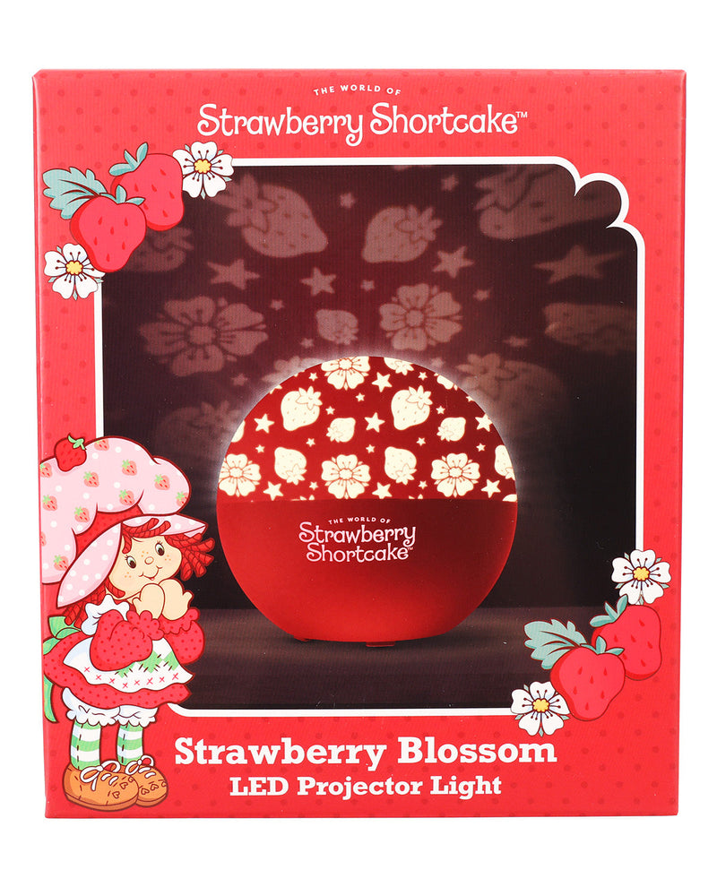 Strawberry Shortcake LED projector light in its retail packaging, featuring a red box with illustrations of Strawberry Shortcake and the text 'Strawberry Blossom LED Projector Light'.