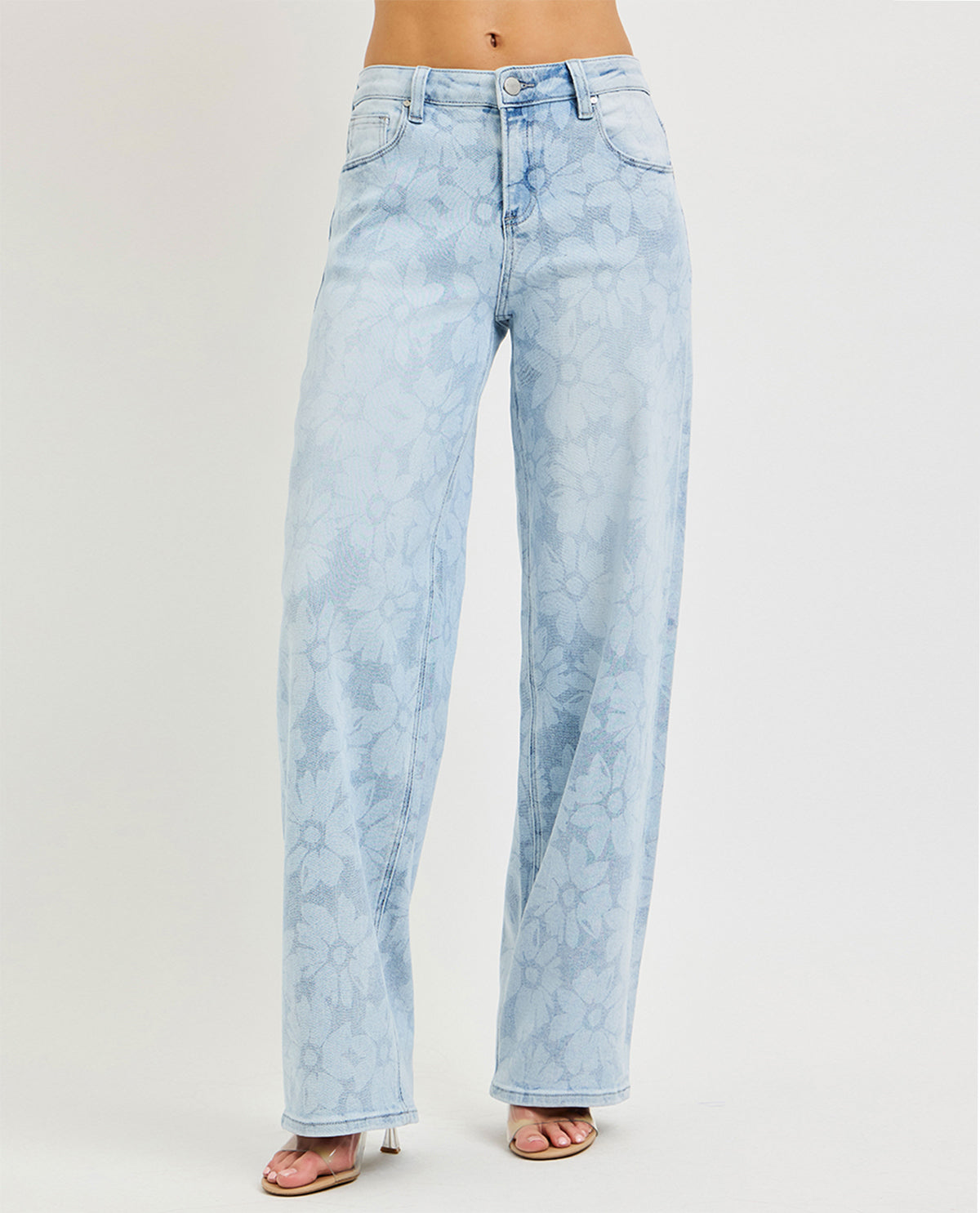 Model wearing long wide leg floral jeans