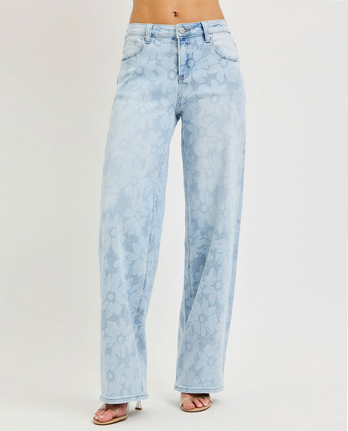 Model wearing long wide leg floral jeans
