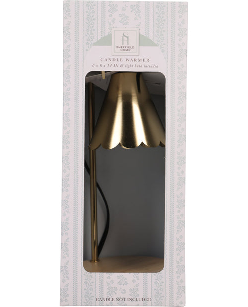 Gold candle warmer in packaging with a visible brand label.